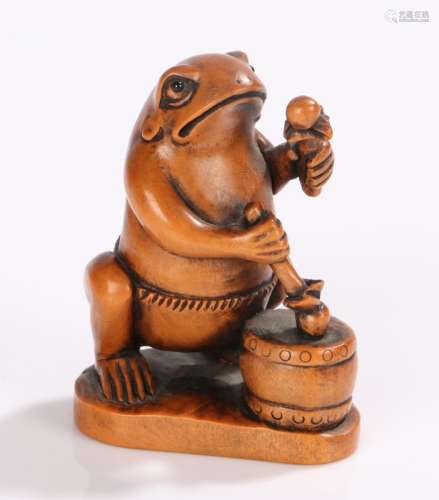 Japanese Meiji period okimono, carved in boxwood as a toad playing a drum, 7cm high