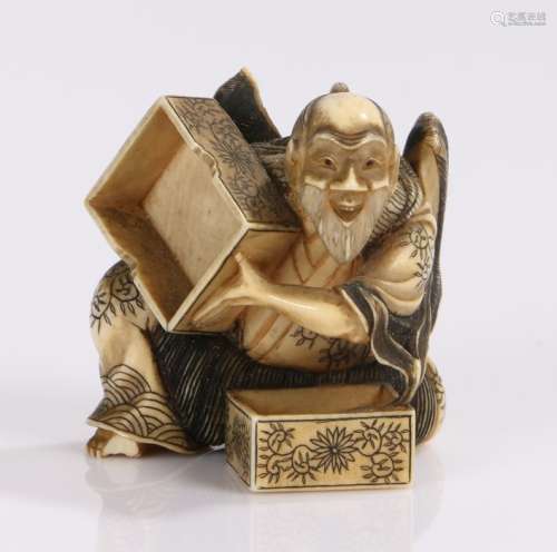Japanese early Meiji period ivory netsuke depicting a bearded man with flowing robes opening a