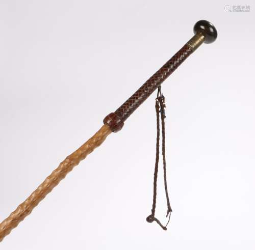 Early 20th Century walking stick, the turned rhinoceros horn grip above a leather handle and thorn