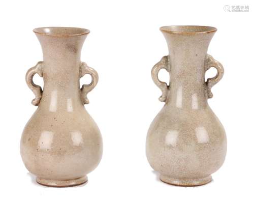 Pair of 18th century celadon vases, with flared rims above pierced handles and bulbous lower