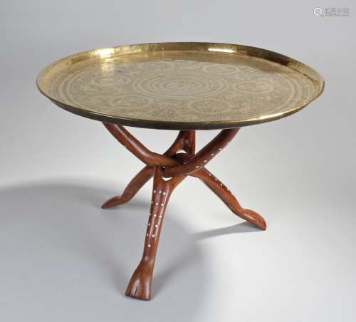 Middle Eastern brass tray on stand, the engraved figural tray top above a hardwood inlaid bone