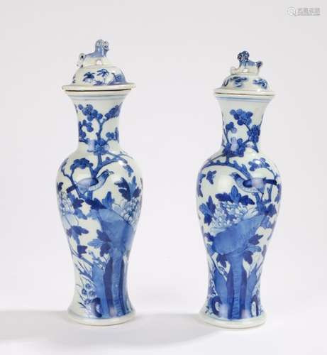 Two Japanese blue and white porcelain vases, with dog of fo form finials to the domed covers, the