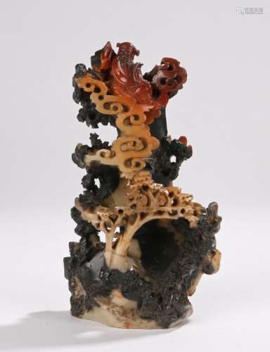 Chinese soapstone sculpture, carved with a figure above rocks and trees, 20cm high