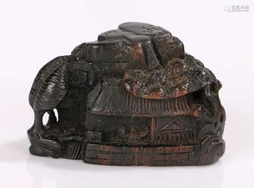 Japanese Meiji period netsuke, the stained box wood netsuke depicts Chinese buildings on a rocky