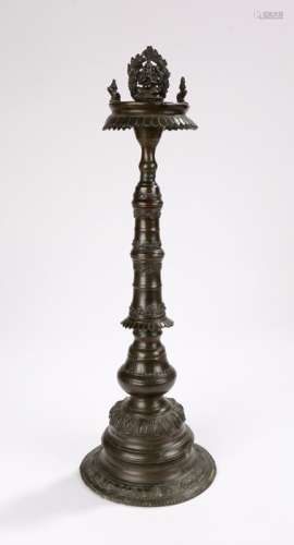 Late 19th Century Indian oil lamp of cast bronze the top surmounted with the figure of Ganesha