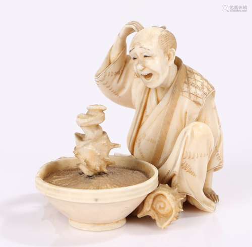 Japanese Meiji period ivory okimono, the okimono carved as a seated man looking with amazement at