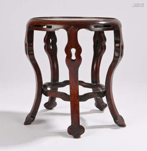 Chinese hardwood stand, with a circular top above arched undulating legs, 19cm wide, 21cm high