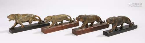 Four horn carvings, depicting prowling tigers, on wooden plinth bases, 17cm wide (4)