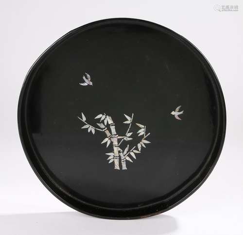 Chinese black lacquer tray, of circular form, the central field with mother of pearl inlay depicting