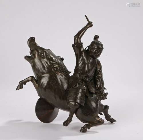 Meiji cast figure of a Samurai astride a boar, the boar rearing as the Samurai holds it's tail