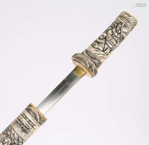 Meiji period bone wakizashi, the hilt and scabbard of carved bone with intricate figural design,