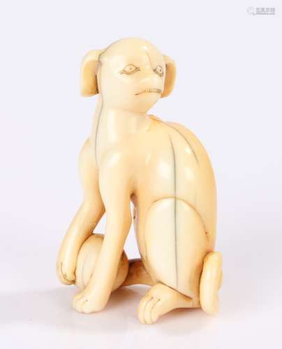 Japanese Edo period netsuke, the ivory netsuke depicting a seated dog with a paw on a ball, 5.5cm