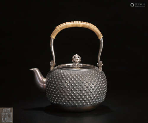 A SILVER MOLDED RIVET PATTERN WATER POT