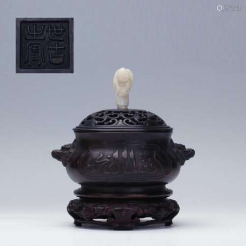 An old bronze censer with white jade carved figure