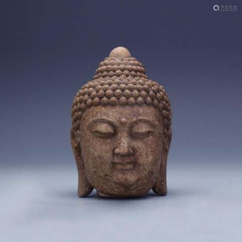 An old limestone carved Buddha head figure