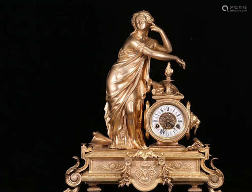 A GILT COPPER CARVED FIGURE SHAPED CLOCK