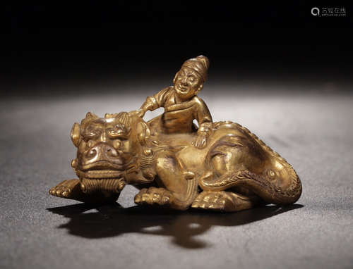 A GILT COPPER FIGURE AND BEAST PENDANT