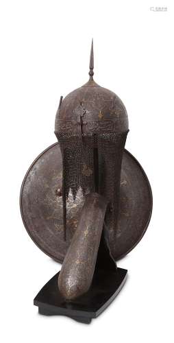 A QAJAR GOLD-DAMASCENED AND SILVER-INLAID STEEL HELMET, SHIELD AND ARMGUARD.