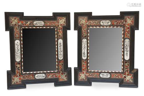 A PAIR OF ITALIAN EBONISED WALL MIRRORS.