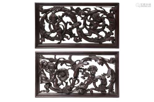 A PAIR OF CARVED WOODEN PANELS.