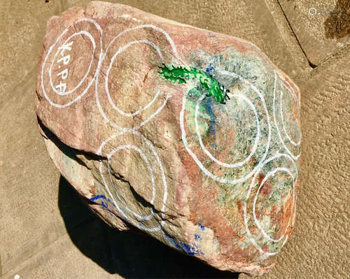 A BURMESE GREEN JADEITE STONE, A CLASS