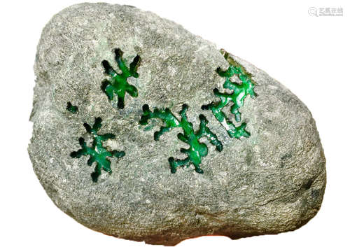 A BURMESE GREEN JADEITE STONE, A CLASS