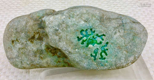 A BURMESE GREEN JADEITE STONE, A CLASS