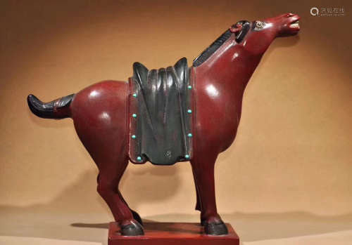 A RED LACQUER HORSE FIGURE