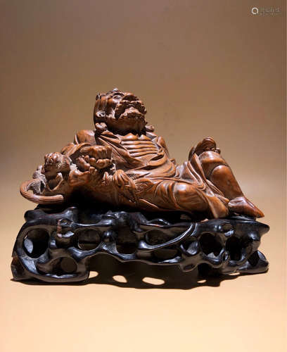 A HUANGYANG WOOD CARVED FIGUE ORNAMENT