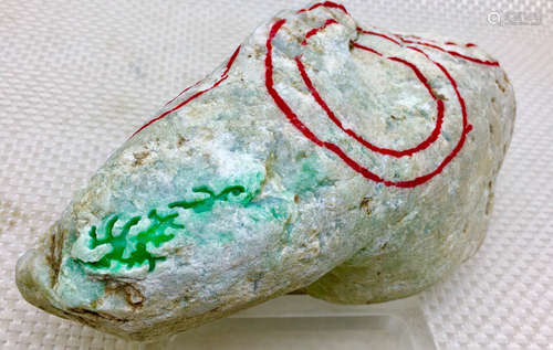 A BURMESE GREEN JADEITE STONE, A CLASS