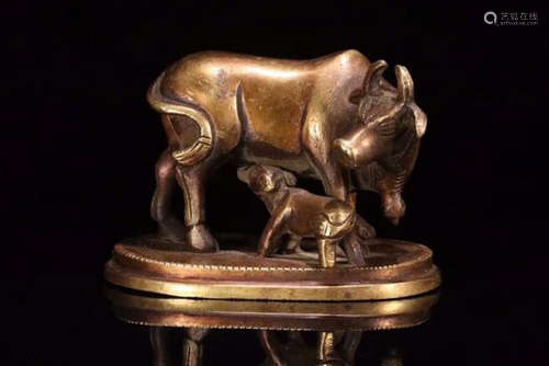 A BRONZE CASTED COW SHAPED PENDANT