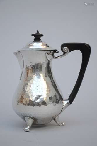 A small coffeepot in hammered silver