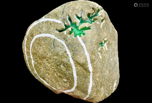 A BURMESE GREEN JADEITE STONE, A CLASS