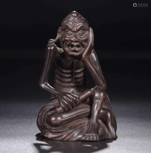 A ZITAN WOOD CARVED LUOHAN FIGURE