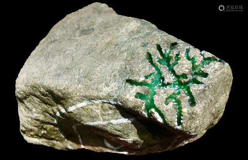 A BURMESE GREEN JADEITE STONE, A CLASS