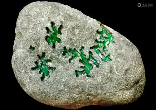 A BURMESE GREEN JADEITE STONE, A CLASS