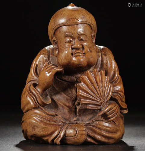A BAMBOO CARVED RELAXED FIGURE