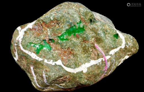 A BURMESE GREEN JADEITE STONE, A CLASS