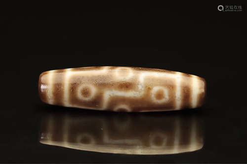 AN OLD TIBETAN NINE-EYE DZI BEAD