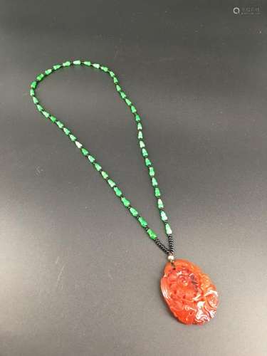 A carnelian carved jadeite necklace