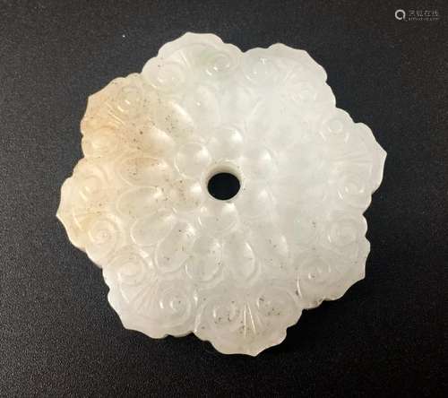 An old white jade carved plum blossom form ornament