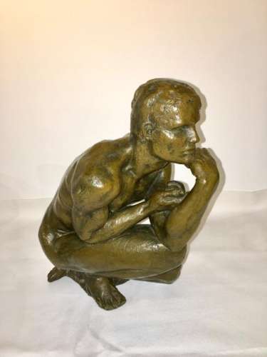 A solid bronze figure of a man thinking; signed