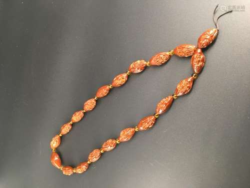 A carved walnut necklace