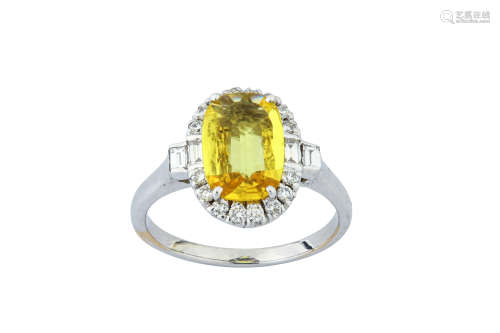 A yellow sapphire and diamond cluster ring