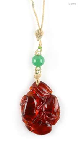 A Chinese carved amber pendant modelled as fruit & leaves, 18th / 19th century, on string necklace