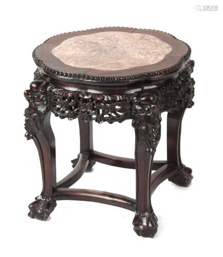A late 19th / early 20th century Chinese carved hongmu stand with pink marble inset top, 19ins. (