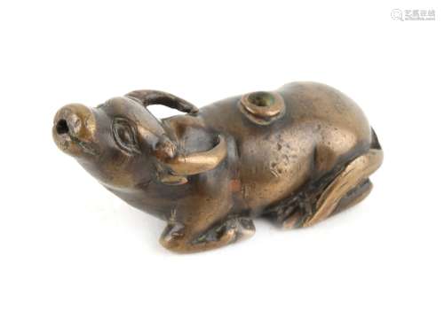 A Chinese bronze water dropper modelled as a recumbent buffalo, 17th / 18th century, 2.7ins. (6.