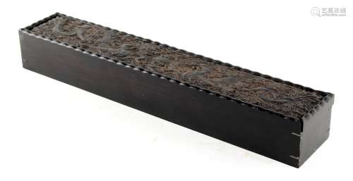 A 19th century Chinese blackwood scroll box, the sliding lid carved with two opposing dragons