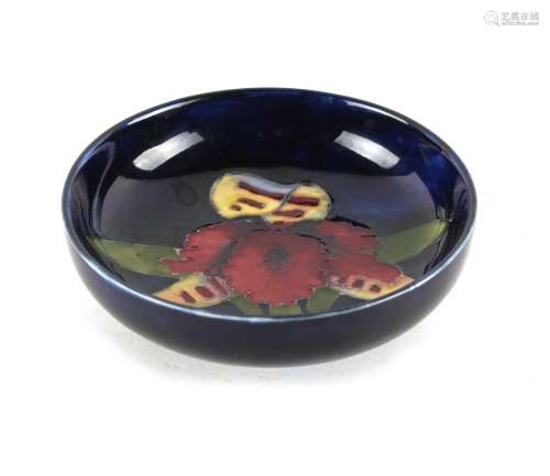 Property of a lady - a Moorcroft orchid pattern shallow bowl, with original paper label to