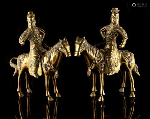Property of a lady - a pair of Chinese polished bronze models of warriors on horseback, each inset